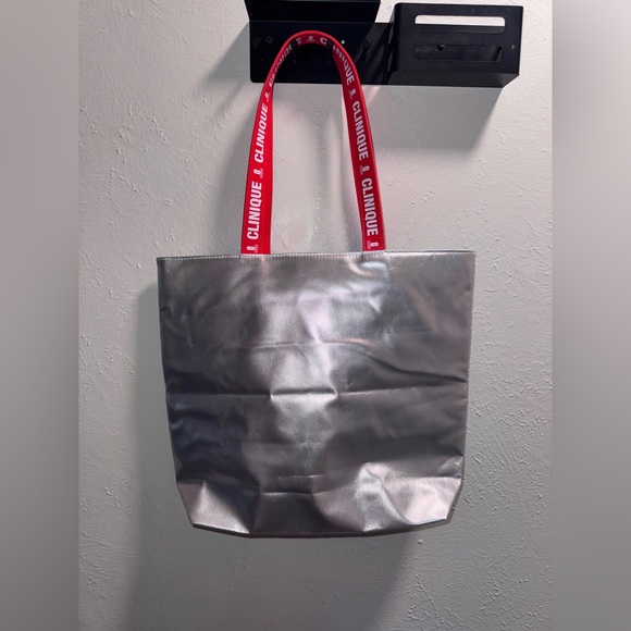 Clinique Handbags - Clinique Silver Red Reflective Tote Bag